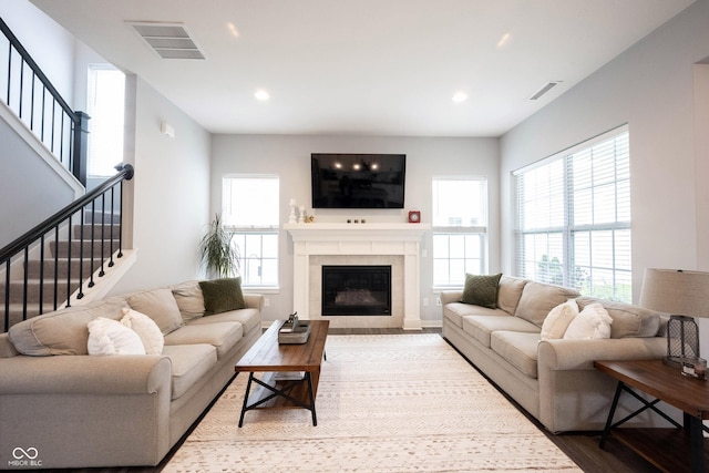 1534 Cloverdon Dr, Westfield, IN 46074 - living room with stairway, wood finished floors, recessed lighting, and a tiled fireplace