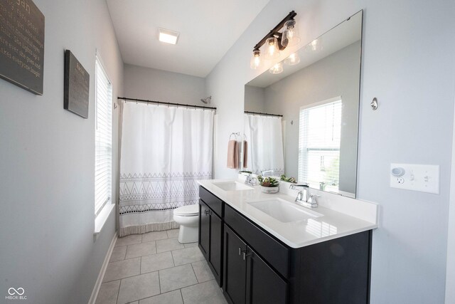 1534 Cloverdon Dr, Westfield, IN 46074 - full bath with double vanity, toilet, tile patterned flooring, baseboards, and shower / tub combo