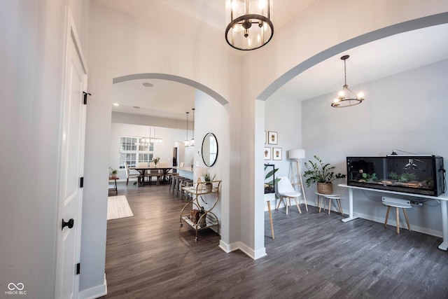 1534 Cloverdon Dr, Westfield, IN 46074 - foyer featuring a chandelier, arched walkways, dark wood-style flooring, a high ceiling, and baseboards