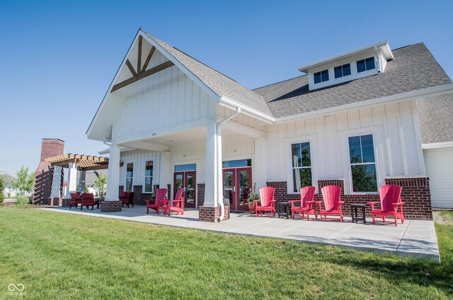 1534 Cloverdon Dr, Westfield, IN 46074 - back of property featuring board and batten siding, a shingled roof, a pergola, a lawn, and a patio area