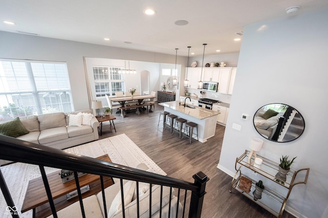 1534 Cloverdon Dr, Westfield, IN 46074 - living room featuring dark wood-type flooring, recessed lighting, a chandelier, and baseboards