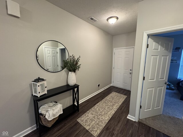 914 Baden Manor Dr, Indianapolis, IN 46217 - foyer entrance featuring dark wood-style floors, baseboards, and a textured ceiling