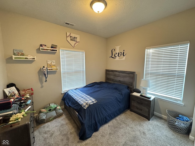 914 Baden Manor Dr, Indianapolis, IN 46217 - carpeted bedroom with baseboards, a textured ceiling, and multiple windows