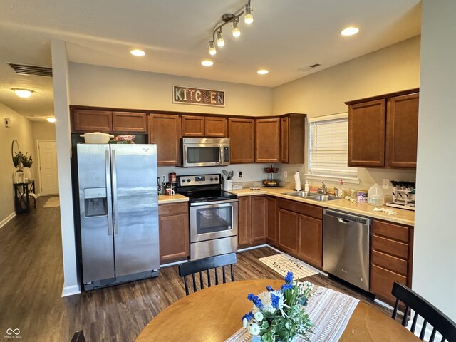 914 Baden Manor Dr, Indianapolis, IN 46217 - kitchen with appliances with stainless steel finishes, dark wood finished floors, a sink, light countertops, and recessed lighting