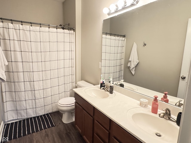 914 Baden Manor Dr, Indianapolis, IN 46217 - full bathroom featuring wood finished floors, toilet, double vanity, and a shower with shower curtain