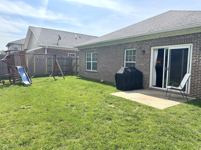 914 Baden Manor Dr, Indianapolis, IN 46217 - back of property featuring brick siding, a playground, a patio area, and a shingled roof