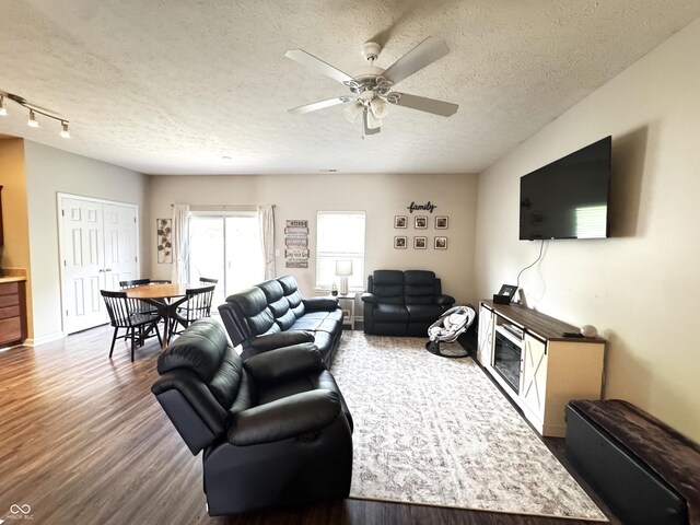 914 Baden Manor Dr, Indianapolis, IN 46217 - living area featuring dark wood-style flooring, ceiling fan, a textured ceiling, and baseboards
