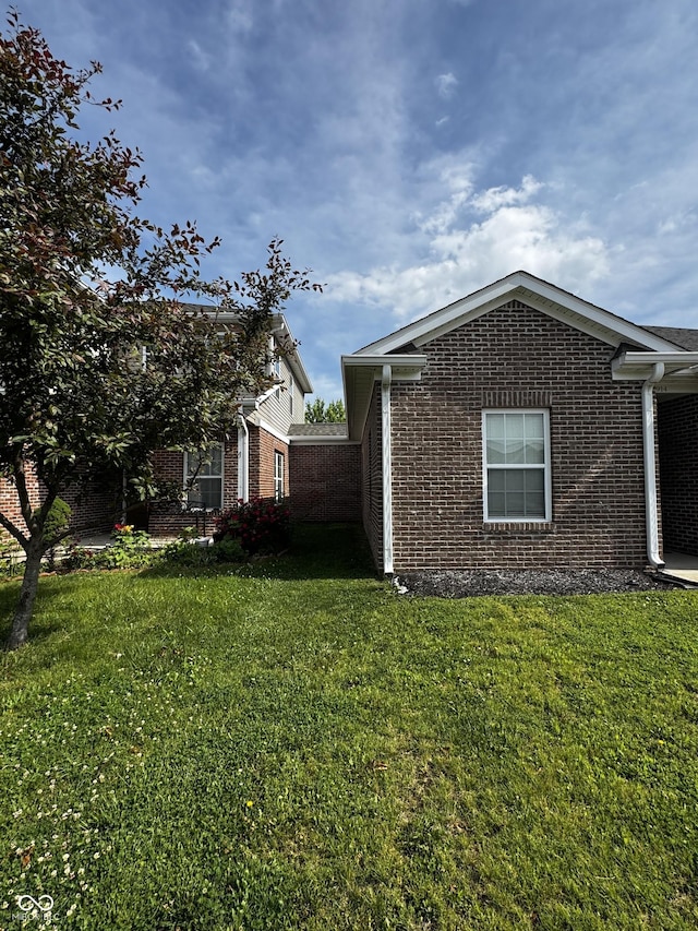 914 Baden Manor Dr, Indianapolis, IN 46217 - view of side of home featuring brick siding and a yard