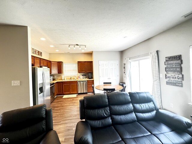 914 Baden Manor Dr, Indianapolis, IN 46217 - living room with light wood finished floors, recessed lighting, and a textured ceiling