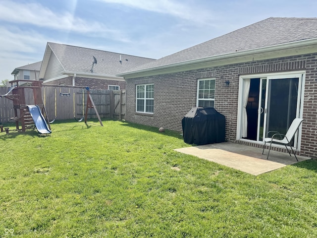 914 Baden Manor Dr, Indianapolis, IN 46217 - back of house featuring brick siding, a playground, a patio area, and roof with shingles