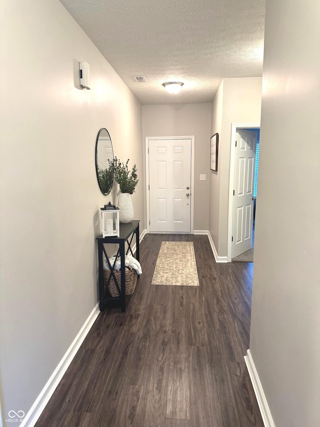 914 Baden Manor Dr, Indianapolis, IN 46217 - entryway with dark wood finished floors, a textured ceiling, and baseboards