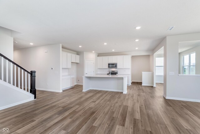 2741 Penn Ave, Plainfield, IN 46168 - unfurnished living room with light wood finished floors, recessed lighting, and stairs