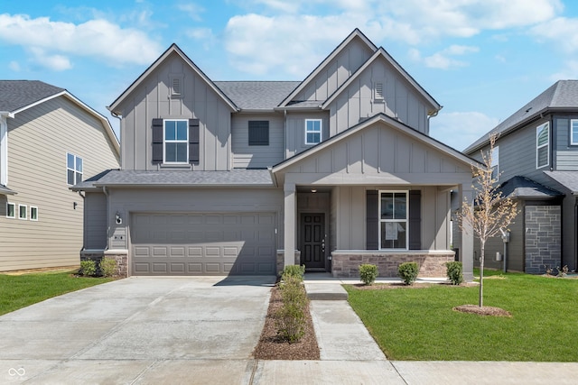 2741 Penn Ave, Plainfield, IN 46168 - craftsman-style house featuring board and batten siding, stone siding, driveway, a front lawn, and a shingled roof