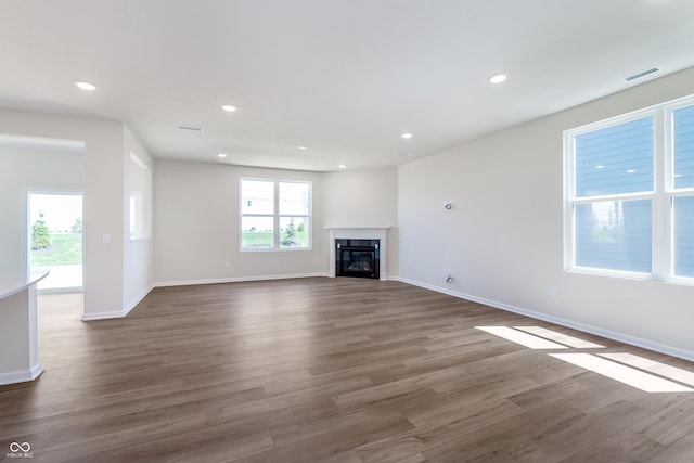 2741 Penn Ave, Plainfield, IN 46168 - unfurnished living room with plenty of natural light, dark wood-style flooring, recessed lighting, and a glass covered fireplace