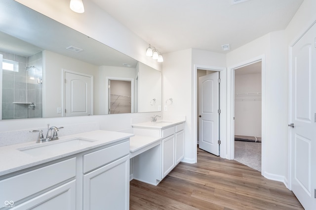 2741 Penn Ave, Plainfield, IN 46168 - full bath with double vanity, a spacious closet, tiled shower, and wood finished floors