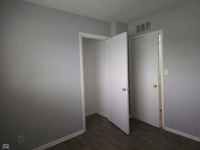 1931 Brentwood Dr, Anderson, IN 46011 - unfurnished bedroom featuring visible vents, baseboards, and dark wood finished floors