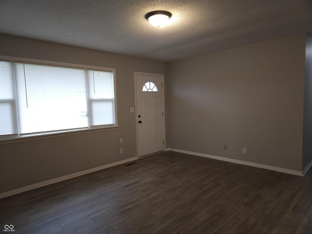 1931 Brentwood Dr, Anderson, IN 46011 - entryway with dark wood-style flooring, baseboards, and a textured ceiling