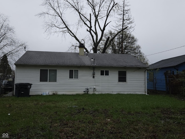 1931 Brentwood Dr, Anderson, IN 46011 - rear view of house featuring a lawn and a chimney