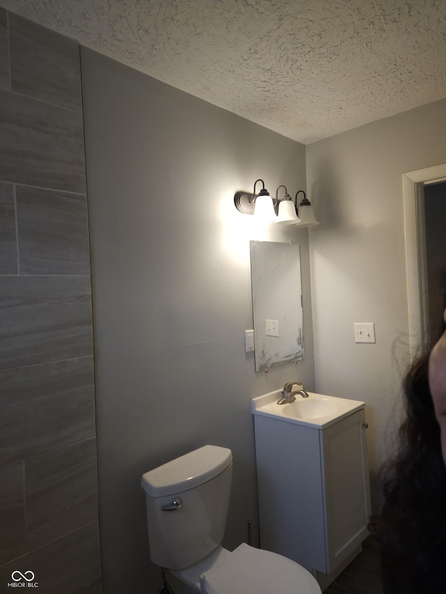 1931 Brentwood Dr, Anderson, IN 46011 - half bath featuring toilet, vanity, and a textured ceiling