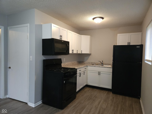 1931 Brentwood Dr, Anderson, IN 46011 - kitchen featuring a sink, black appliances, white cabinetry, and dark wood-style floors