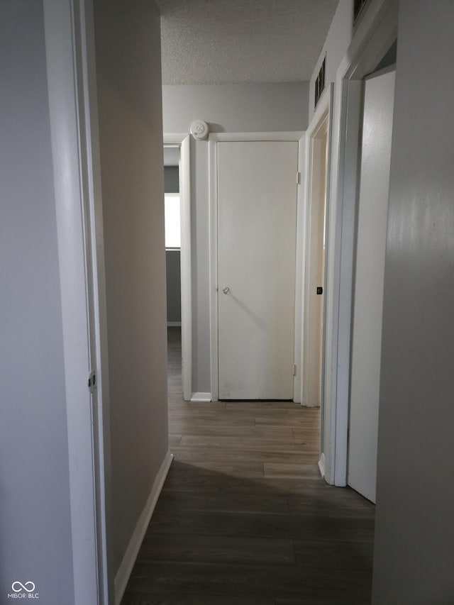 1931 Brentwood Dr, Anderson, IN 46011 - corridor featuring visible vents, baseboards, and wood finished floors