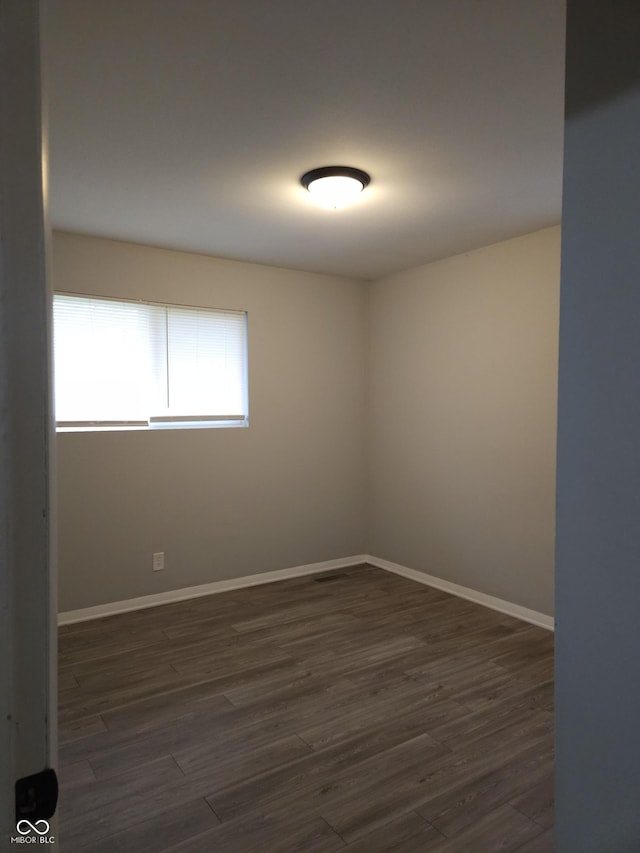 1931 Brentwood Dr, Anderson, IN 46011 - spare room featuring baseboards and dark wood-style floors