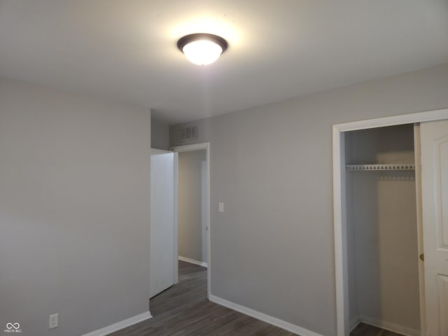 1931 Brentwood Dr, Anderson, IN 46011 - unfurnished bedroom with a closet, baseboards, and dark wood finished floors