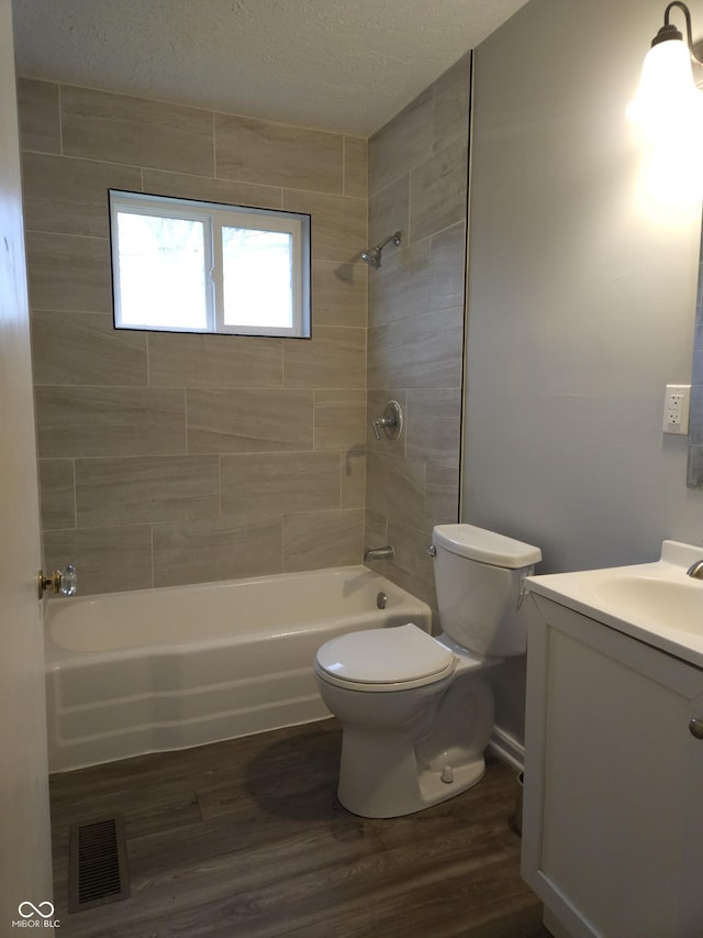 1931 Brentwood Dr, Anderson, IN 46011 - full bath with visible vents, toilet, vanity, wood finished floors, and bathing tub / shower combination