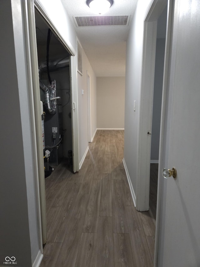 1931 Brentwood Dr, Anderson, IN 46011 - hall with visible vents, baseboards, and wood finished floors