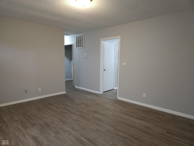 1931 Brentwood Dr, Anderson, IN 46011 - empty room featuring a textured ceiling, dark wood-style flooring, baseboards, and visible vents