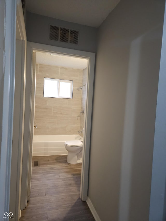 1931 Brentwood Dr, Anderson, IN 46011 - bathroom featuring visible vents, toilet, wood finished floors, and shower / bathtub combination