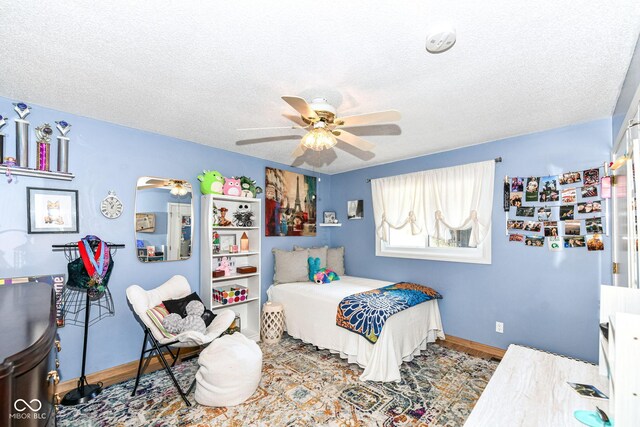 1153 Diablo Rd, Greenwood, IN 46143 - bedroom featuring wood finished floors, a textured ceiling, baseboards, and ceiling fan