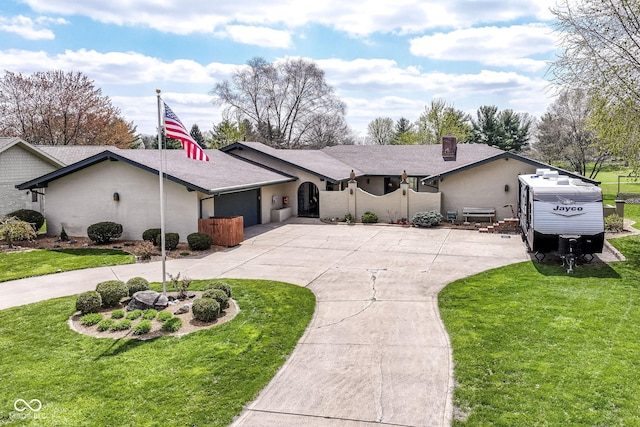 1153 Diablo Rd, Greenwood, IN 46143 - ranch-style home with curved driveway, a front lawn, and a chimney