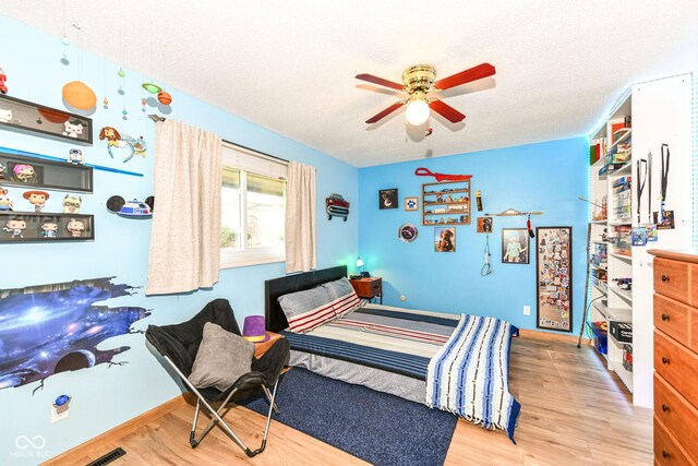 1153 Diablo Rd, Greenwood, IN 46143 - bedroom featuring visible vents, baseboards, wood finished floors, and a textured ceiling