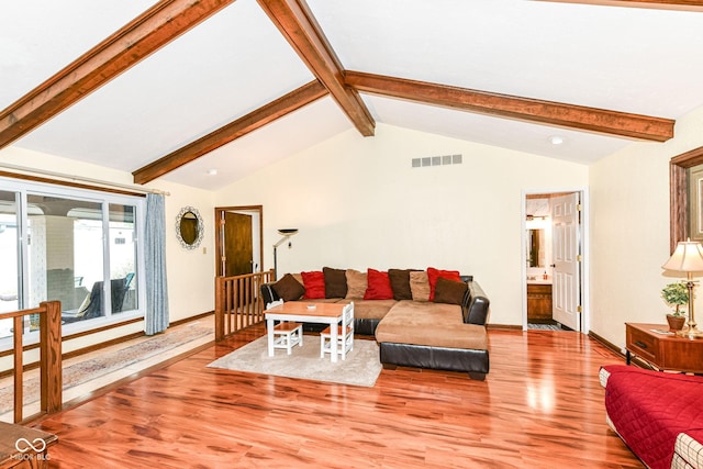 1153 Diablo Rd, Greenwood, IN 46143 - living area featuring wood finished floors, baseboards, vaulted ceiling with beams, and visible vents
