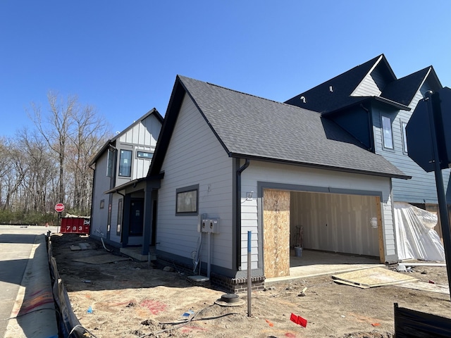 16375 Burlwood Dr, Westfield, IN 46074 - view of side of property featuring an attached garage and a shingled roof