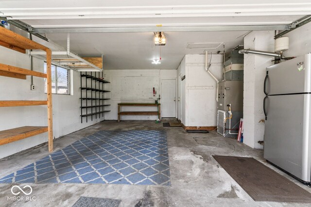 10129 Guilford Ave, Carmel, IN 46280 - garage featuring freestanding refrigerator and a garage door opener