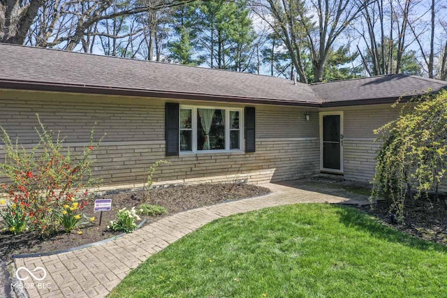 10129 Guilford Ave, Carmel, IN 46280 - exterior space featuring a lawn, a shingled roof, and brick siding