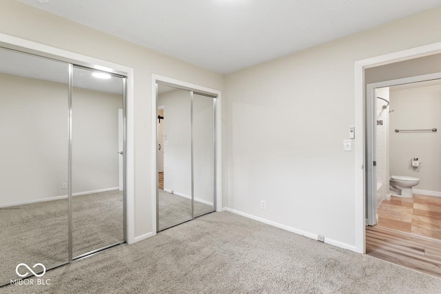 10129 Guilford Ave, Carmel, IN 46280 - unfurnished bedroom featuring carpet, two closets, ensuite bathroom, and baseboards