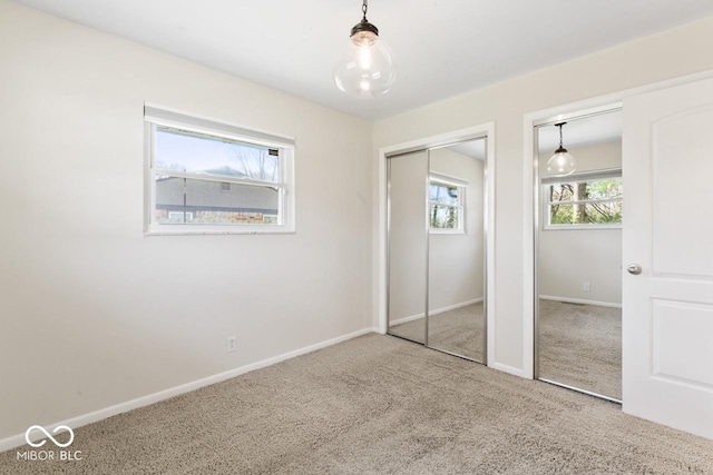 10129 Guilford Ave, Carmel, IN 46280 - unfurnished bedroom featuring two closets, baseboards, and carpet floors