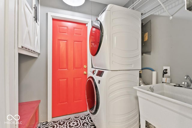 10129 Guilford Ave, Carmel, IN 46280 - laundry room featuring cabinet space, stacked washer / drying machine, and a sink