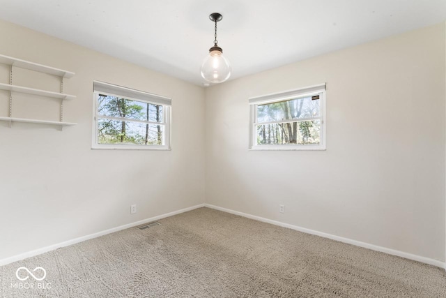 10129 Guilford Ave, Carmel, IN 46280 - spare room with visible vents, plenty of natural light, carpet flooring, and baseboards
