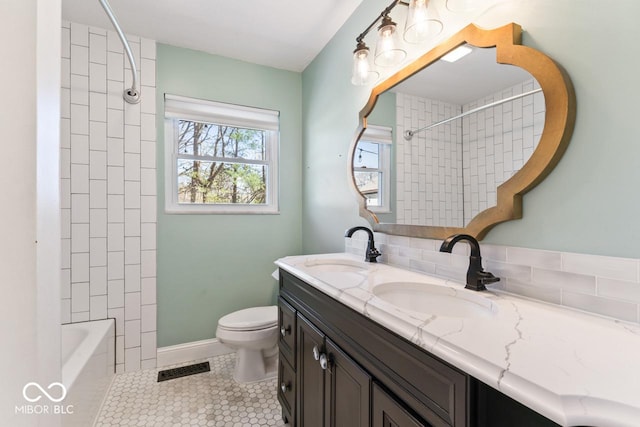 10129 Guilford Ave, Carmel, IN 46280 - bathroom with toilet, double vanity, a sink, and tile patterned floors