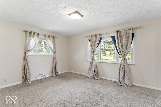 10129 Guilford Ave, Carmel, IN 46280 - spare room featuring a textured ceiling, a healthy amount of sunlight, visible vents, and carpet