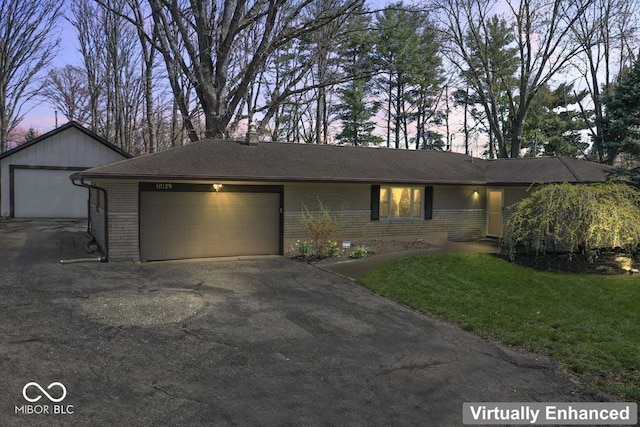 10129 Guilford Ave, Carmel, IN 46280 - view of front of home with brick siding, aphalt driveway, a front yard, and an attached garage