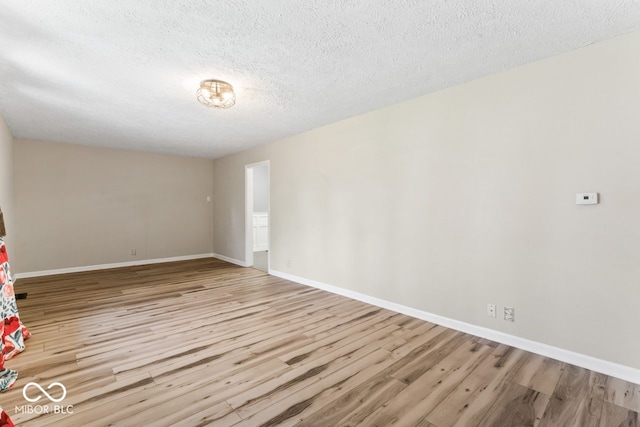 10129 Guilford Ave, Carmel, IN 46280 - spare room with baseboards, wood finished floors, and a textured ceiling