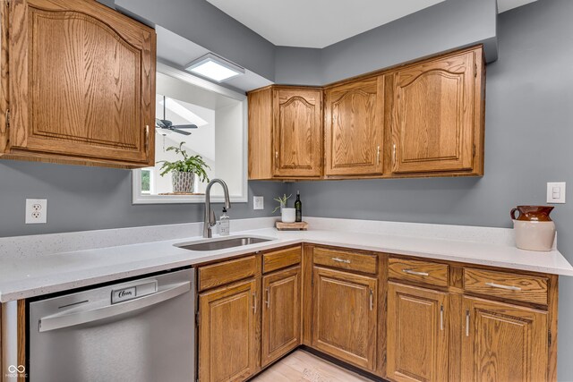 7205 Steven Ln, Indianapolis, IN 46260 - kitchen featuring stainless steel dishwasher, a sink, light countertops, and brown cabinetry