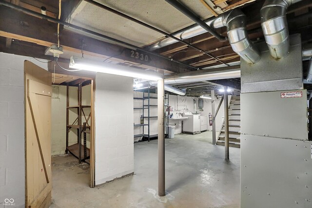 unfinished below grade area with washing machine and dryer and stairway