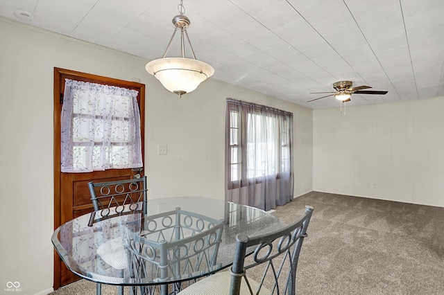 dining space featuring carpet flooring and ceiling fan