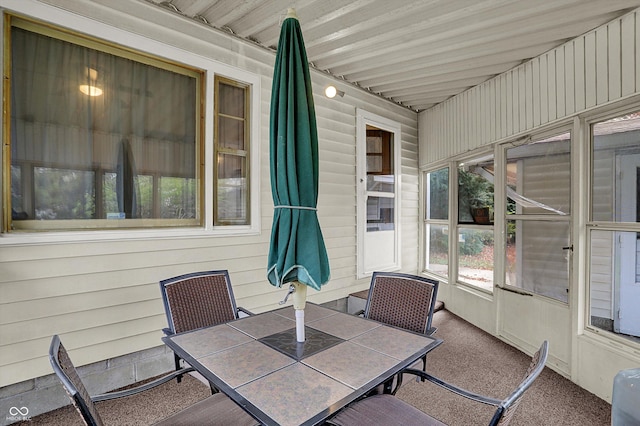 sunroom / solarium featuring outdoor dining space